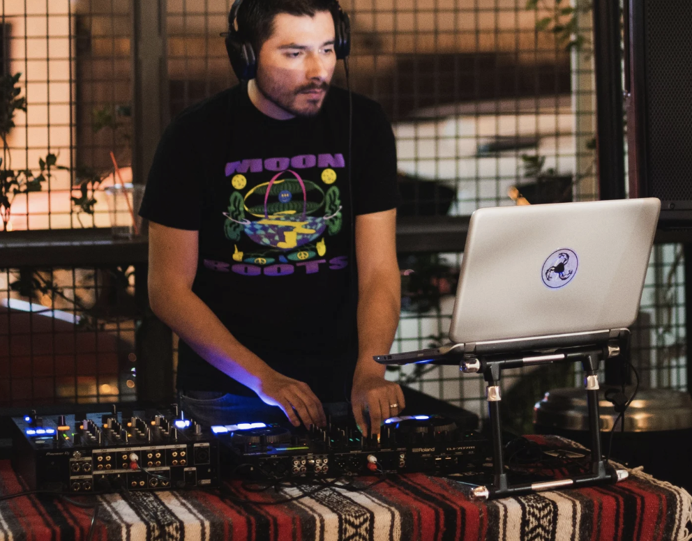 DJ mixing live on the BLVD MRKT patio